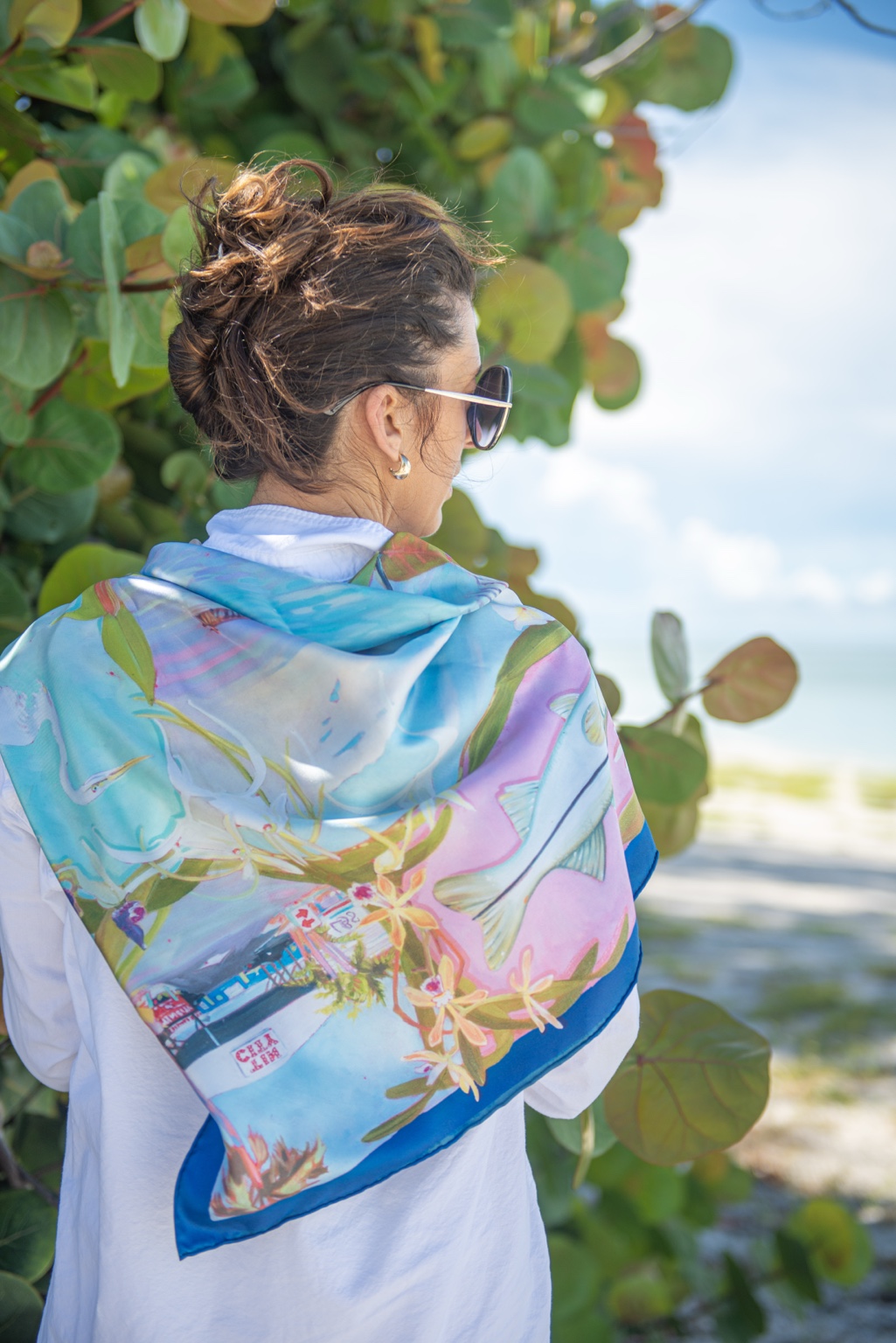The actual navy Naples silk scarf worn over the shoulders outdoors